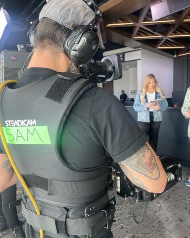 Steadicam — operator at the rig, indoors.