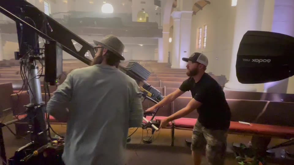 Jeff May Music Video (2021) — Jib. Two operators on the crane's boom in the sanctuary, its white columns and pews around them.