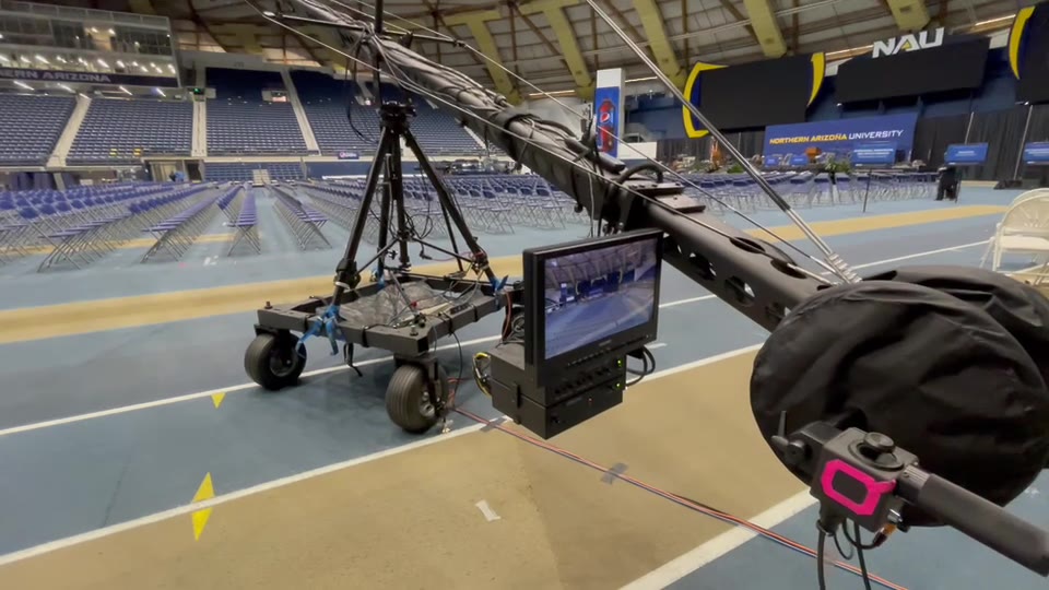 NAU Spring Commencement (2022) — Jib. The arena before the ceremony: the Jib base and its covered camera head on the floor, with the court and seating behind.